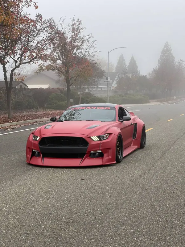 Red widebody Ford Mustang on the street